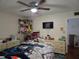 Bedroom featuring a metal bed frame, a TV, and a collection of stuffed animals displayed on the wall at 1912 Cattleya Dr # 1912, Kissimmee, FL 34741