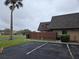 Two-story brick home with a private fenced patio, as seen from the parking lot on an overcast day at 1912 Cattleya Dr # 1912, Kissimmee, FL 34741