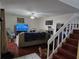 Cozy living room with hardwood floors, a ceiling fan, a sofa, and a staircase with wood stairs at 1912 Cattleya Dr # 1912, Kissimmee, FL 34741