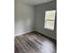 Simple bedroom design with wood-look flooring and a bright window offering outdoor views at 1926 Sw 160Th Sw Pl # 03, Ocala, FL 34470