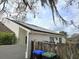 Exterior of house featuring solar panels on the roof and tidy backyard area at 2452 Atrium Cir, Orlando, FL 32808