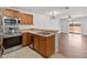 Spacious kitchen featuring stainless appliances, light wood cabinets, and tile flooring at 2913 Ashford Park Pl, Oviedo, FL 32765