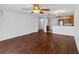 Open-concept living area with ceiling fan, wood flooring, and view into the kitchen at 2913 Ashford Park Pl, Oviedo, FL 32765