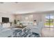 Bright living room with stylish furniture, a decorative rug, and sliding glass doors to the backyard at 3060 Water Clover Ct, Apopka, FL 32712