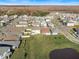 Aerial view of a modern neighborhood featuring well-manicured lawns and tree-lined streets at 3070 Prelude Ln, Kissimmee, FL 34746