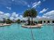 The large community pool features a volleyball net and plenty of chairs to enjoy a sunny day near the attractive clubhouse at 3070 Prelude Ln, Kissimmee, FL 34746