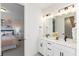 Bright bathroom with dual sinks and a large mirror, and a view into another bedroom at 3235 Legends Preserve Dr, Daytona Beach, FL 32124