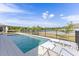 Sparkling swimming pool with sun loungers and a beautiful lake view beyond the fenced yard at 3235 Legends Preserve Dr, Daytona Beach, FL 32124