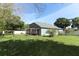 Backyard with a pergola-covered seating area and a large grassy lawn at 324 Lusitano Way, Sanford, FL 32773