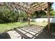 Backyard featuring a covered patio, concrete, wood beams, and grass at 324 Lusitano Way, Sanford, FL 32773