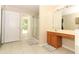 Well-lit bathroom boasts a shower, oak vanity, and tile flooring at 324 Lusitano Way, Sanford, FL 32773