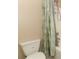 Bathroom showcasing toilet, shower with shower curtain, and storage rack at 324 Lusitano Way, Sanford, FL 32773