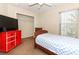 Cozy bedroom with a blue and white bedspread and a red dresser at 324 Lusitano Way, Sanford, FL 32773