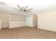 Open bonus room with neutral walls, plush carpeting, and a stylish ceiling fan at 324 Lusitano Way, Sanford, FL 32773