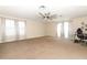 Spacious bonus room featuring large windows, plush carpet, and a decorative fan at 324 Lusitano Way, Sanford, FL 32773