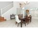 Dining area with tile floors, a tall window and a staircase with white rails at 324 Lusitano Way, Sanford, FL 32773