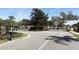 Gated entrance to a community with mature trees and well-maintained landscaping at 324 Lusitano Way, Sanford, FL 32773