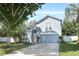 Charming two-story home with a well-manicured lawn, attached garage, and inviting entrance at 324 Lusitano Way, Sanford, FL 32773