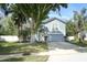 Inviting two-story home with a well-maintained lawn, mature trees, and a cozy exterior at 324 Lusitano Way, Sanford, FL 32773