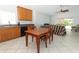 An eat-in kitchen featuring wood cabinets and dark countertops that connects to the living room at 324 Lusitano Way, Sanford, FL 32773