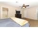 Spacious bedroom with ceiling fan, TV, and ensuite bathroom offers comfort and convenience at 324 Lusitano Way, Sanford, FL 32773