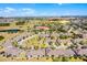 An aerial perspective showcases a neighborhood with a pond, community buildings, and well-spaced homes at 3618 Solana Cir, Clermont, FL 34711