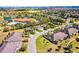 Aerial view of neighborhood highlighting community clubhouse, pool and surrounding green spaces at 3618 Solana Cir, Clermont, FL 34711