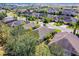 This aerial captures multiple homes in a suburban landscape with lush trees and landscaping at 3618 Solana Cir, Clermont, FL 34711