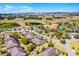 Aerial view featuring homes and community amenities like the clubhouse, pool, and green spaces at 3618 Solana Cir, Clermont, FL 34711