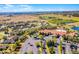 Aerial view of neighborhood clubhouse, landscaping, parking area and nearby green areas at 3618 Solana Cir, Clermont, FL 34711