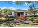 Landscaped backyard showcasing colorful plants and manicured trees at 3618 Solana Cir, Clermont, FL 34711