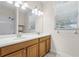 Bathroom with double sinks and large vanity mirror at 3618 Solana Cir, Clermont, FL 34711