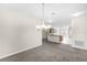 Open dining area with carpet flooring, a chandelier, and views of the kitchen for seamless entertaining at 3618 Solana Cir, Clermont, FL 34711