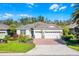 Beautiful single-Gathering home with a well-manicured lawn, a three-car garage, and a brick-paved driveway at 3618 Solana Cir, Clermont, FL 34711