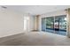 Living room with sliding glass doors to screened patio and neutral color palette at 3618 Solana Cir, Clermont, FL 34711