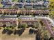 Aerial view of townhomes in a community with trees, landscaping, and a central green space at 3653 Calabria Ave, Davenport, FL 33897