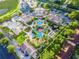 Aerial view of community featuring a large pool area, playground, and meticulously landscaped grounds at 3653 Calabria Ave, Davenport, FL 33897