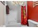 A bathtub/shower combination featuring a Gryffindor themed shower curtain and white tiling at 3653 Calabria Ave, Davenport, FL 33897