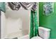 The Slytherin themed bathroom with a toilet, and green shower curtain at 3653 Calabria Ave, Davenport, FL 33897