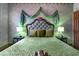 Spacious bedroom featuring a green comforter, and decor draped over headboard at 3653 Calabria Ave, Davenport, FL 33897