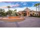 Elegant clubhouse with a decorative fountain, lush landscaping, and a welcoming entrance, ideal for community events at 3653 Calabria Ave, Davenport, FL 33897