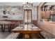 Rustic dining room featuring custom table, exposed brick wall, and charming decor at 3653 Calabria Ave, Davenport, FL 33897