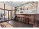 Rustic dining room with exposed brick wall, bar seating, and natural light from the windows at 3653 Calabria Ave, Davenport, FL 33897