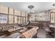 Unique dining room features distressed brick wall, wood floors, chandelier, and wood table with benches at 3653 Calabria Ave, Davenport, FL 33897