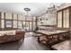 Unique dining room features distressed brick wall, wood floors, chandelier, and wood table with benches at 3653 Calabria Ave, Davenport, FL 33897