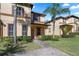 Charming townhome featuring a well-manicured lawn and decorative landscaping, creating inviting curb appeal at 3653 Calabria Ave, Davenport, FL 33897