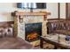 Close-up of the stone fireplace in the living room with electric logs, leather furniture, and a marble table at 3653 Calabria Ave, Davenport, FL 33897