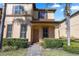 Inviting two-story home with a neatly landscaped front yard and brick walkway to the front door at 3653 Calabria Ave, Davenport, FL 33897