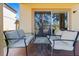 The patio has neutral furniture creating a cozy outdoor living space at 3653 Calabria Ave, Davenport, FL 33897