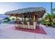 Inviting poolside bar featuring a thatched roof, bar stools, and a relaxing atmosphere surrounded by lush greenery at 3653 Calabria Ave, Davenport, FL 33897